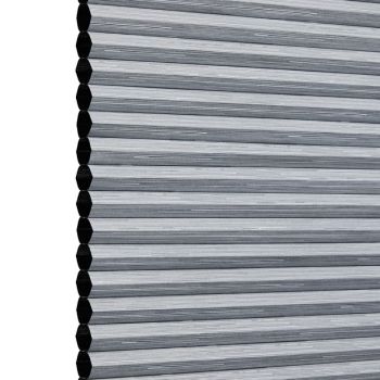 Gray honeycomb cellular blind with visible hexagonal cell edge, fully lowered and closed, blocking view and gently diffusing light against a plain white studio background.