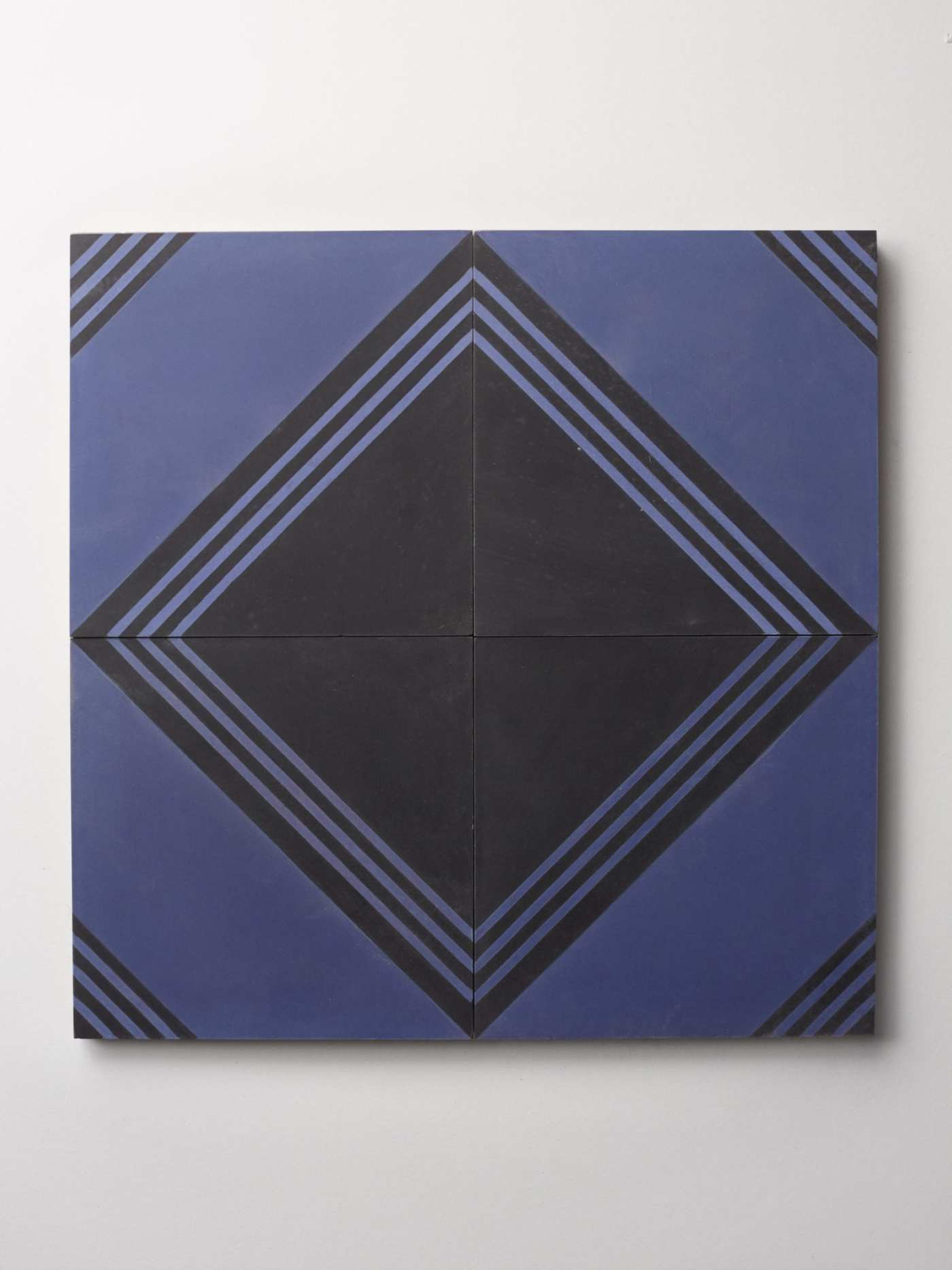 four blue and black tiles forming a diamond pattern.