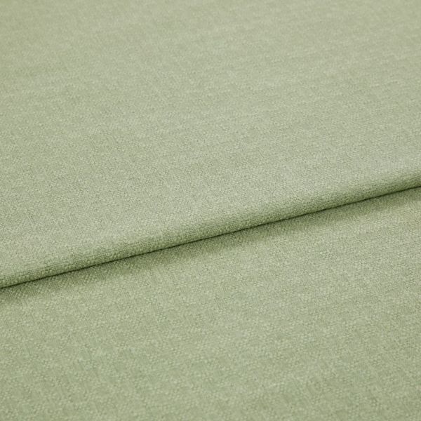 Pale green woven fabric folded once, showing a horizontal overlap and subtle textured weave; lying flat in soft, even studio lighting with a neutral background.