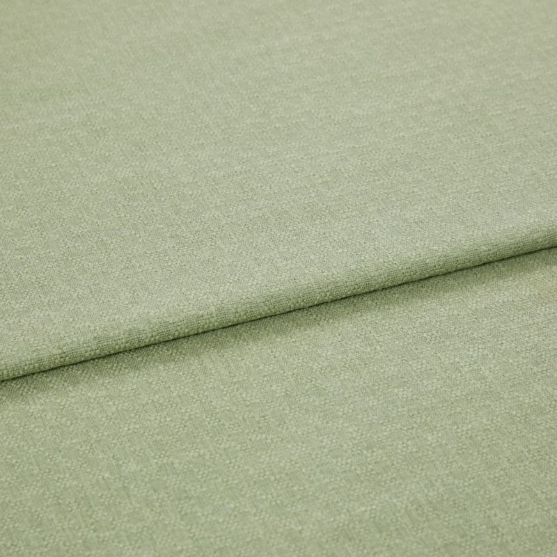 Pale green woven fabric folded once, showing a horizontal overlap and subtle textured weave; lying flat in soft, even studio lighting with a neutral background.