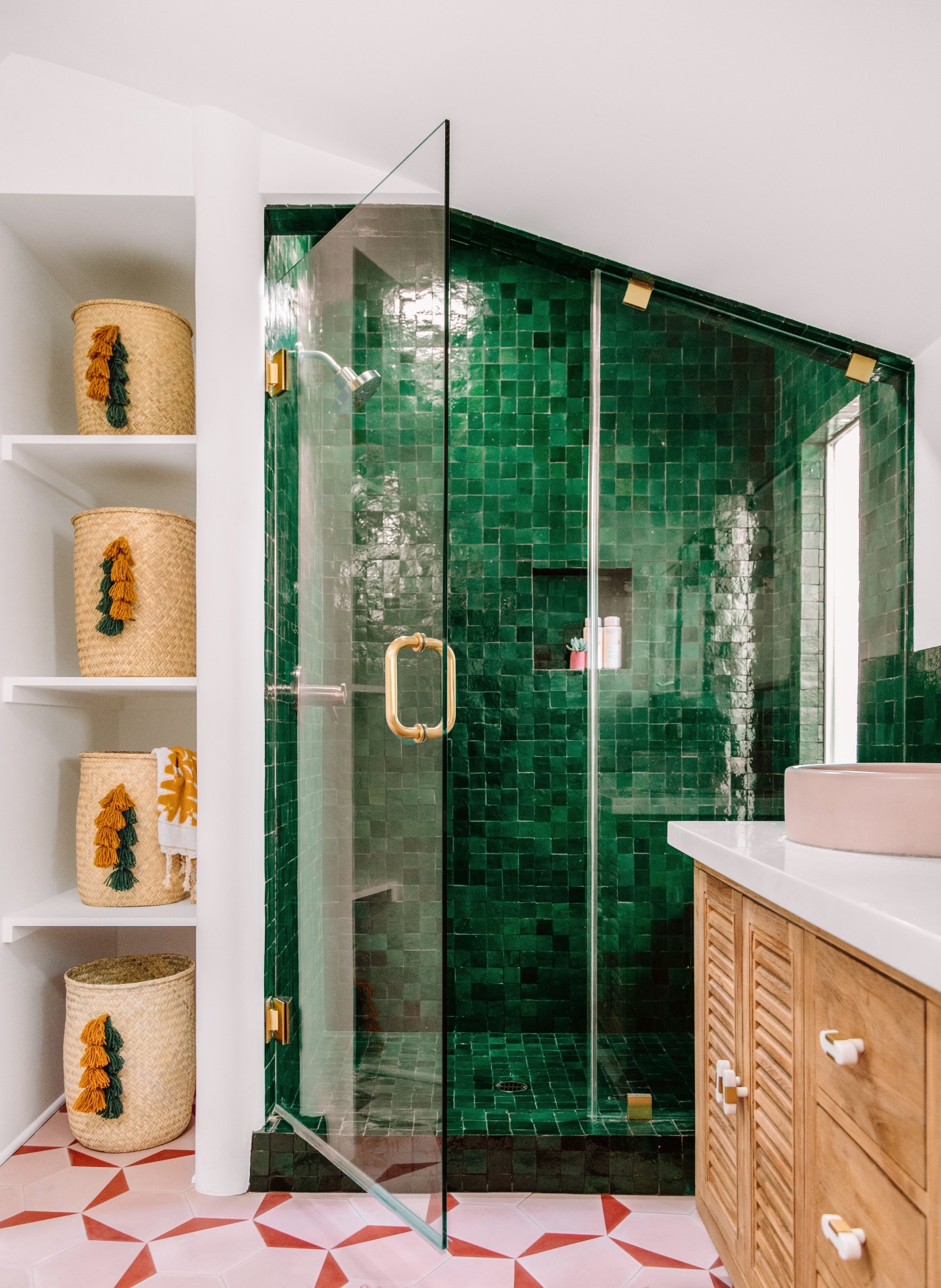 a bathroom with green tiled shower.