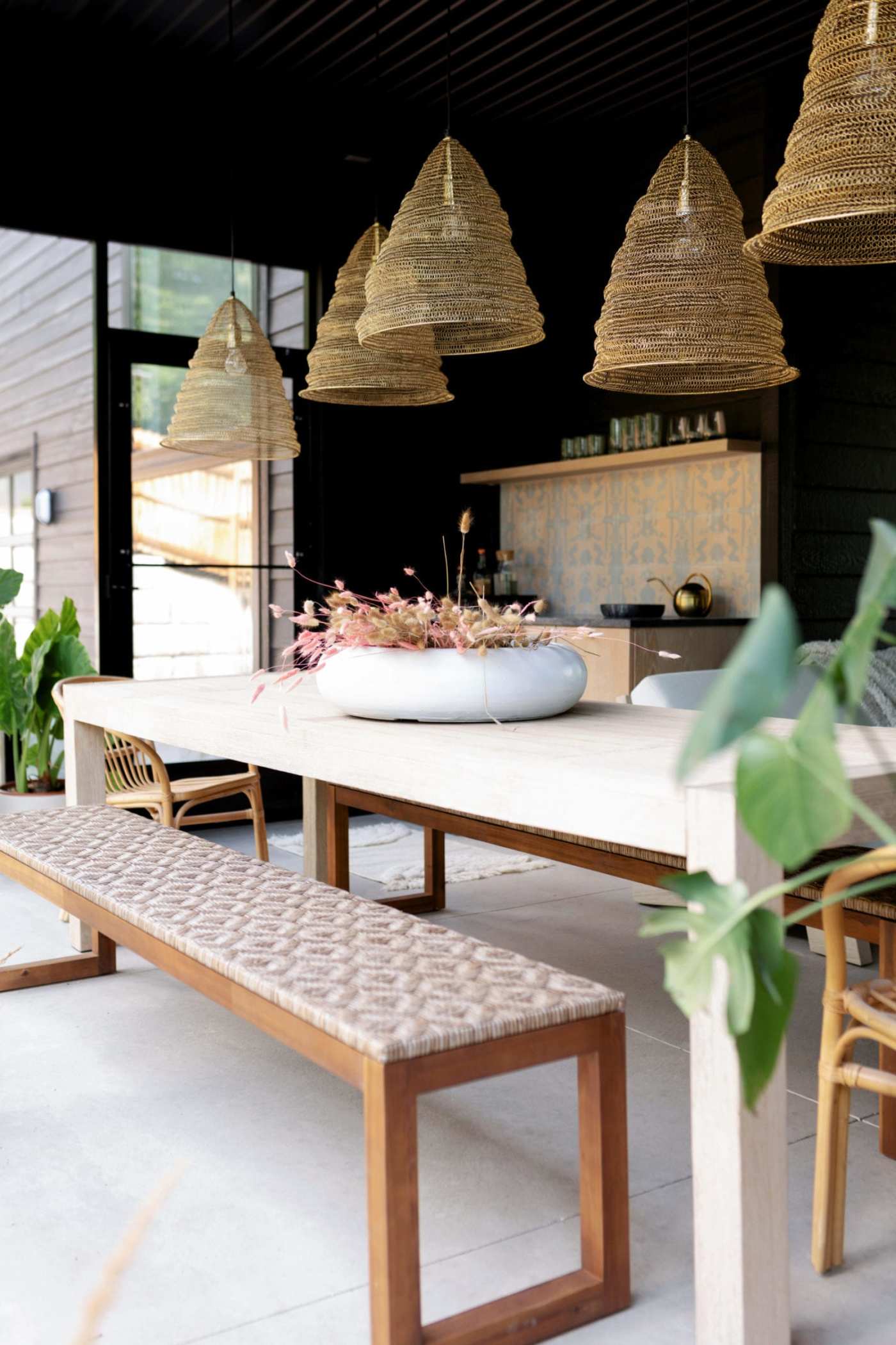 an well decorated dining area with a table and benches.