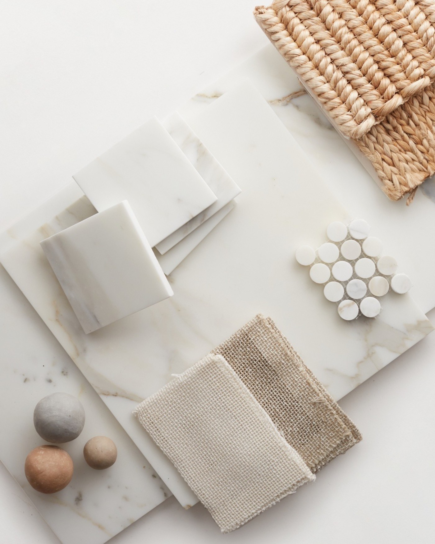 a selection of marble, rattan, and rattan items on a white surface.