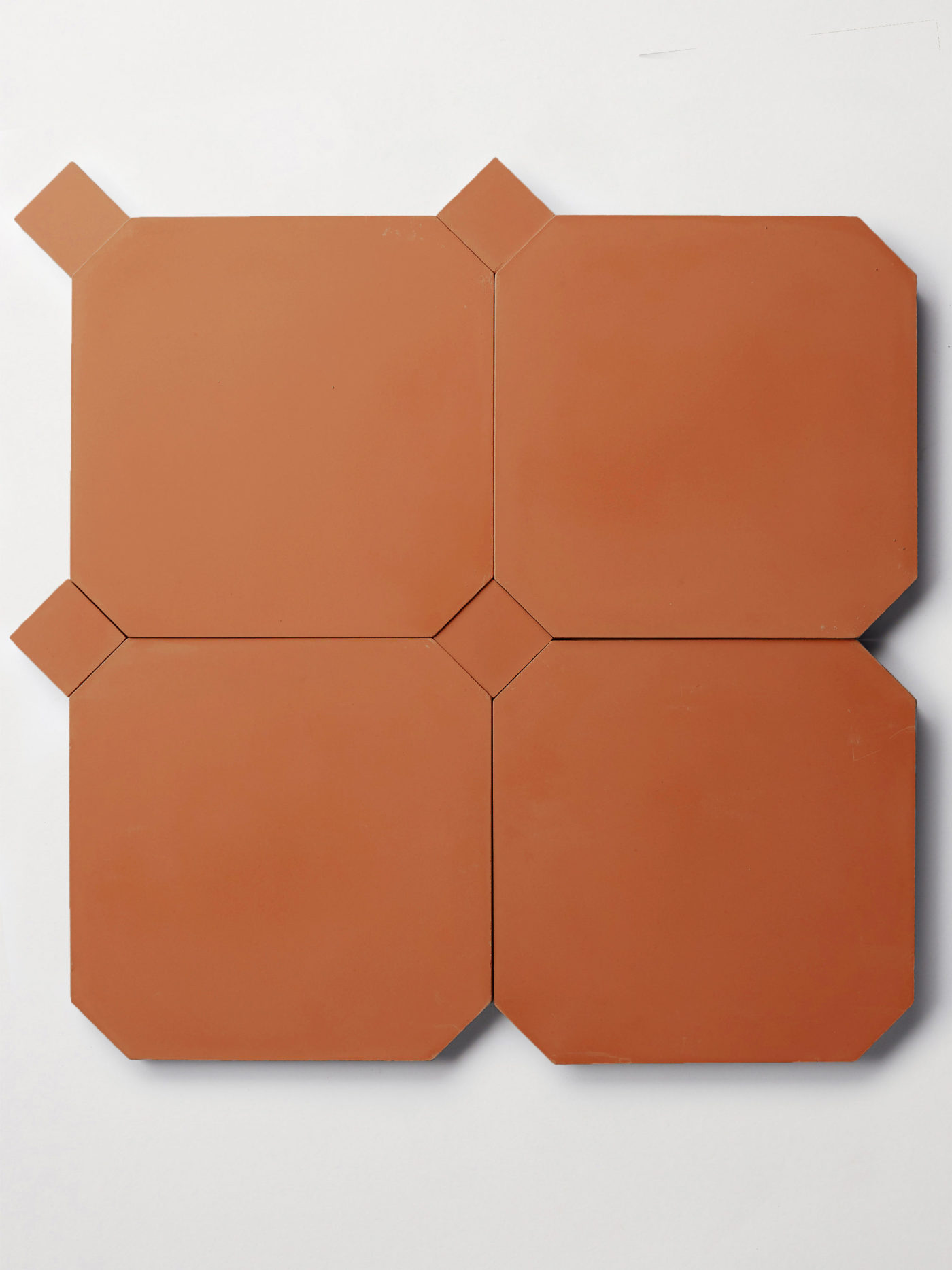 a set of four red octagonal tiles and four smaller red square tiles forming a pattern on a white surface.