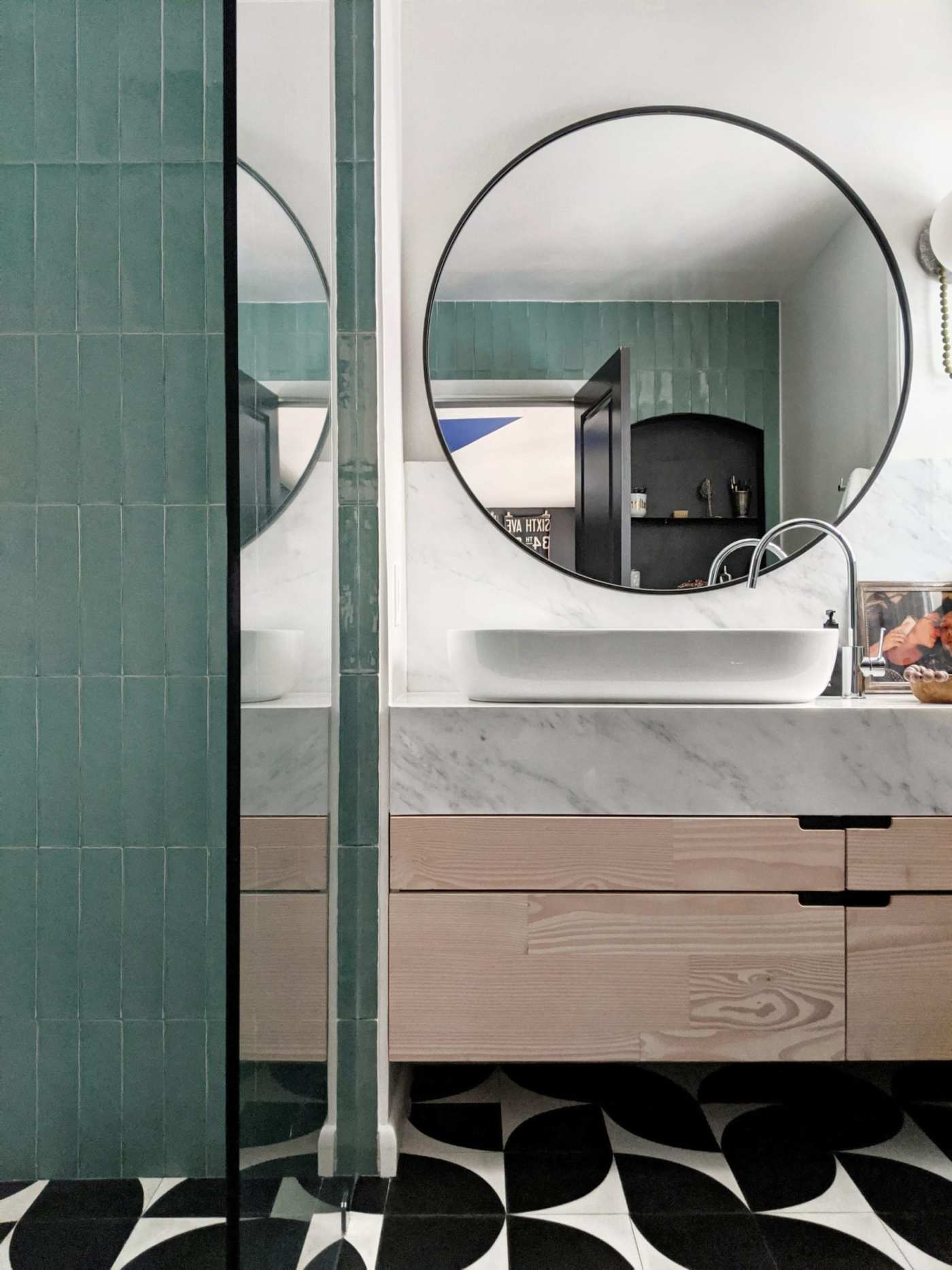 a bathroom with a black and white tiled floor.