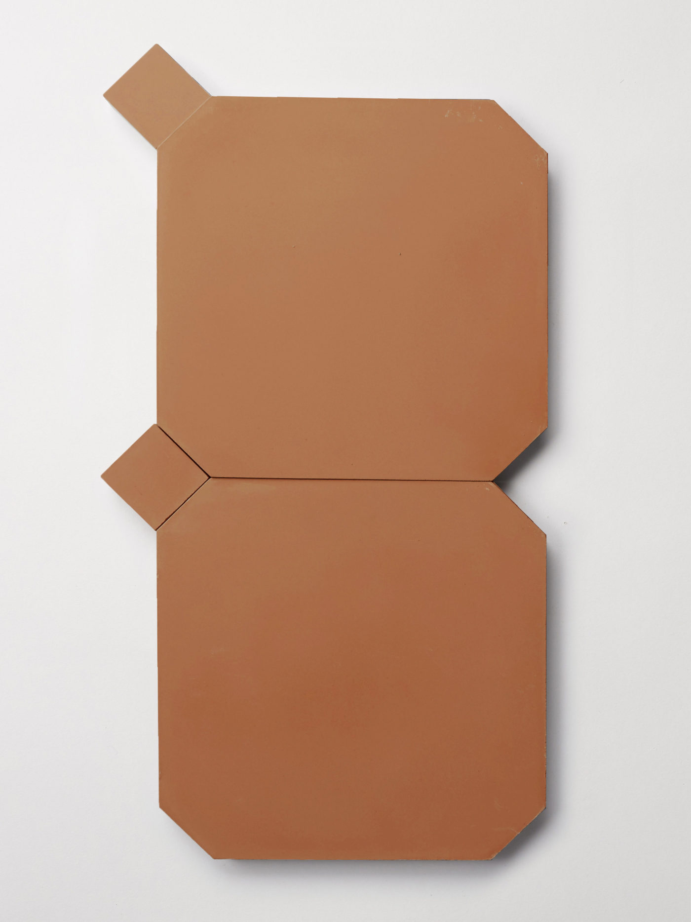 a set of terracotta colored tiles on a white surface.