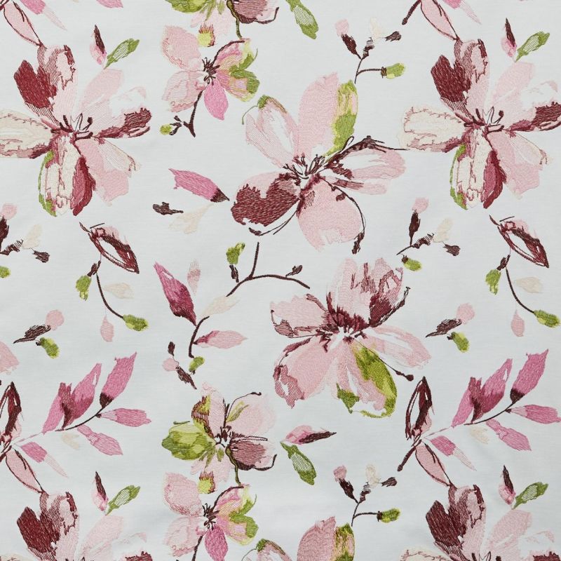 Floral fabric with large embroidered-style pink, burgundy, and green blossoms and buds â€” repeating pattern scattered across the surface â€” flat, evenly lit white background.