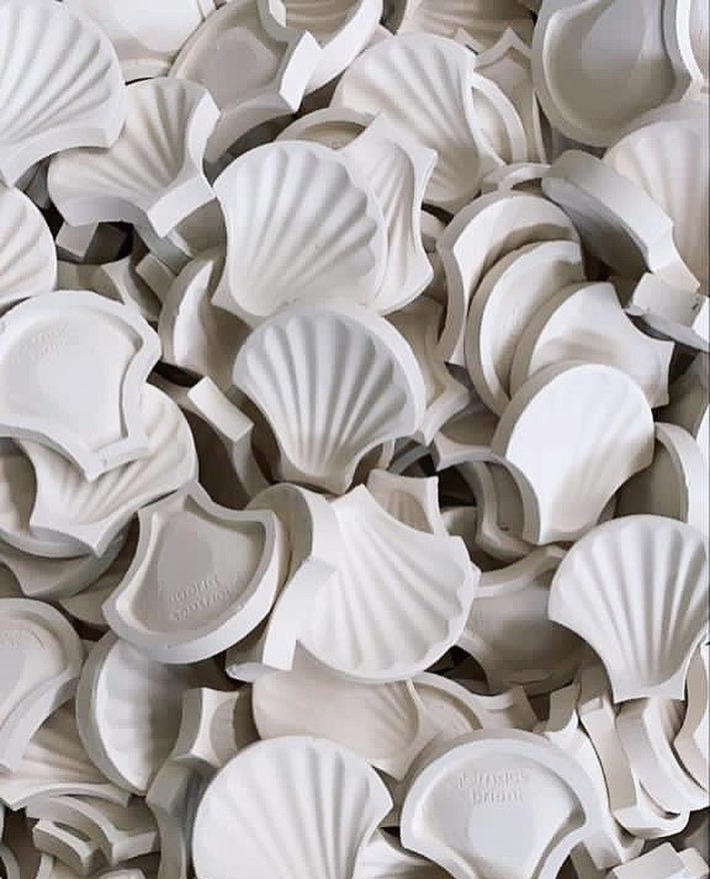 a pile of white shell tiles on a table.