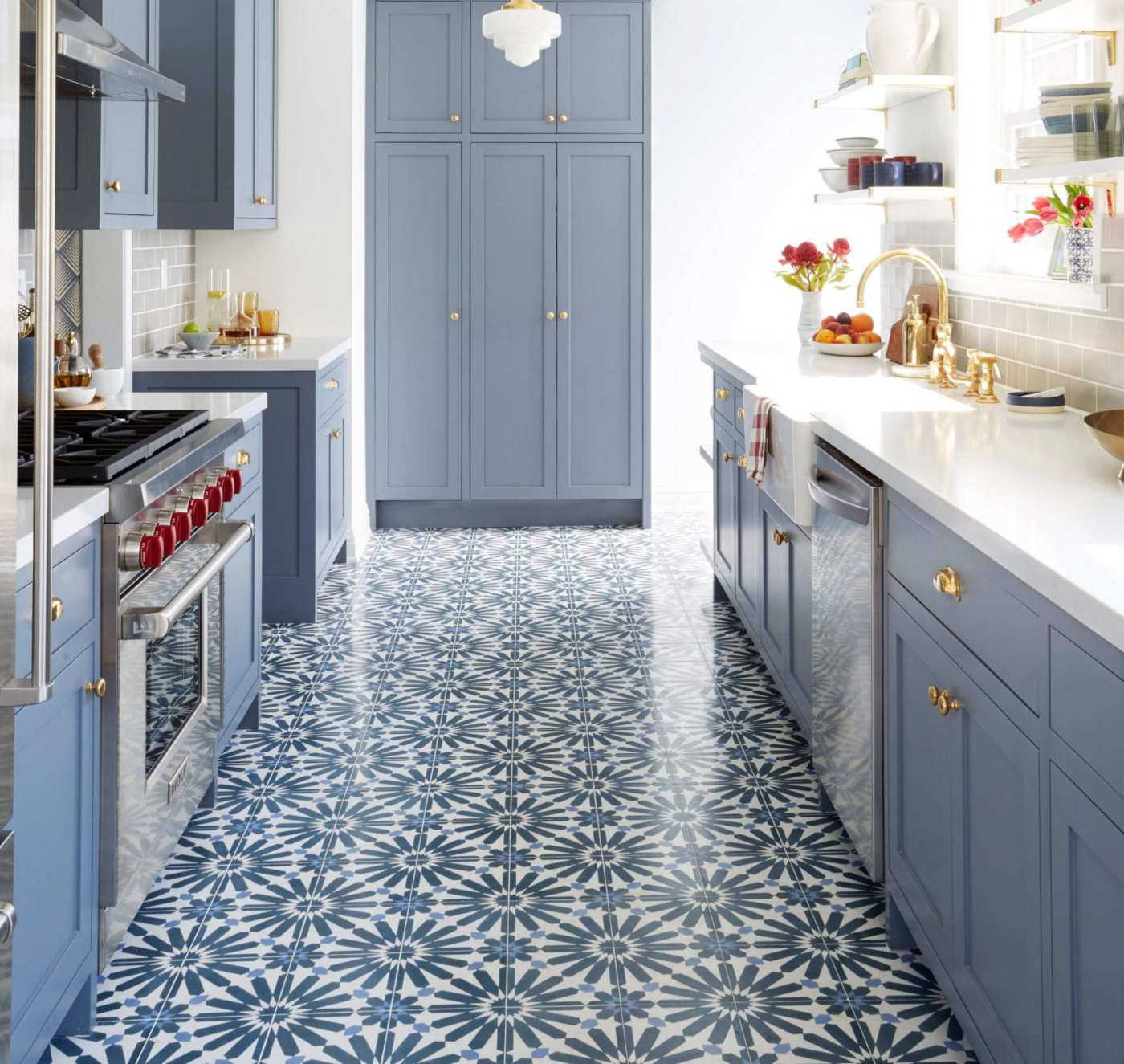 a blue and white kitchen with a tiled floor.