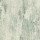 Distressed abstract wall pattern displays vertical streaks and irregular splotches across a subtle teal, gray, and beige field, resembling weathered plaster or washed paint on a wall.