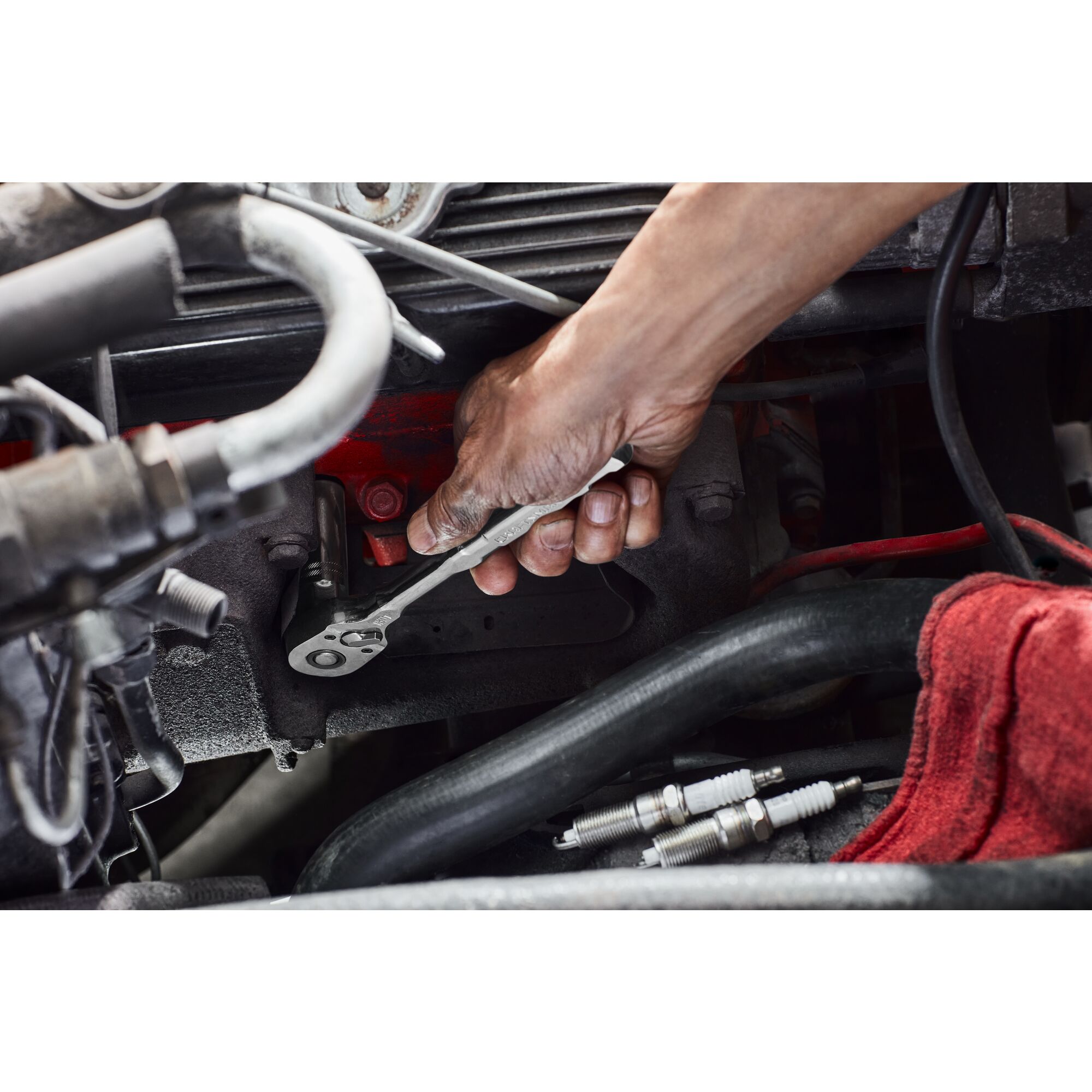 User removing spark plug in a tight area
