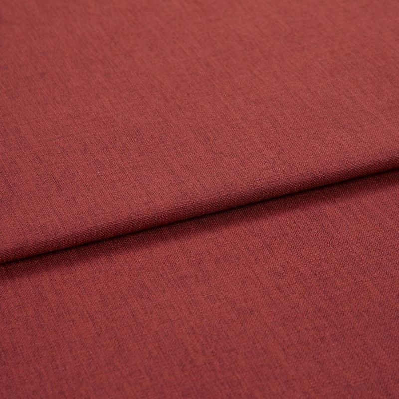 A folded red-brown woven upholstery fabric, folded once across the frame; fine, even weave visible, shown in close-up with soft, even studio lighting.