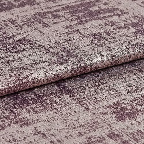 A folded roll of textured metallic mauve upholstery fabric with irregular crushed pattern â€” lying flat, photographed close-up under soft studio lighting to highlight its sheen.