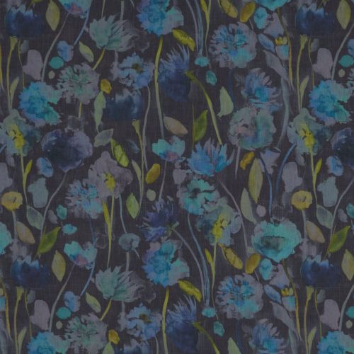 Floral fabric with watercolor-style blue and teal blossoms and slender green stems; pattern covers a dark charcoal surface, resembling wallpaper or curtain in soft, muted lighting.