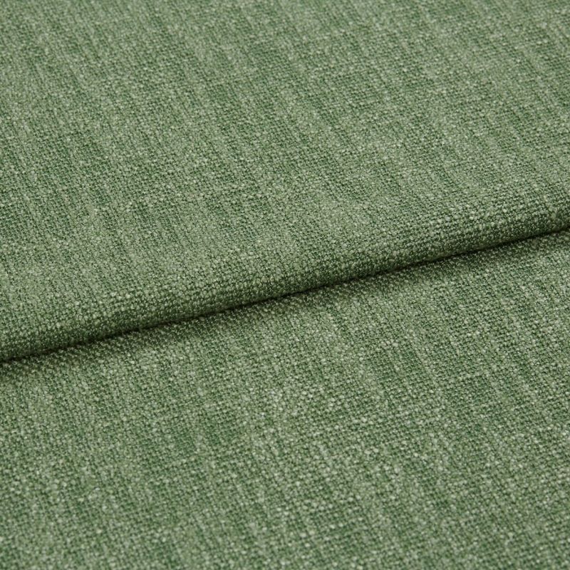 Green woven upholstery fabric, folded with an overlapping edge across the center; textured loop-and-yarn weave; close-up studio shot with soft, even lighting on a neutral background.