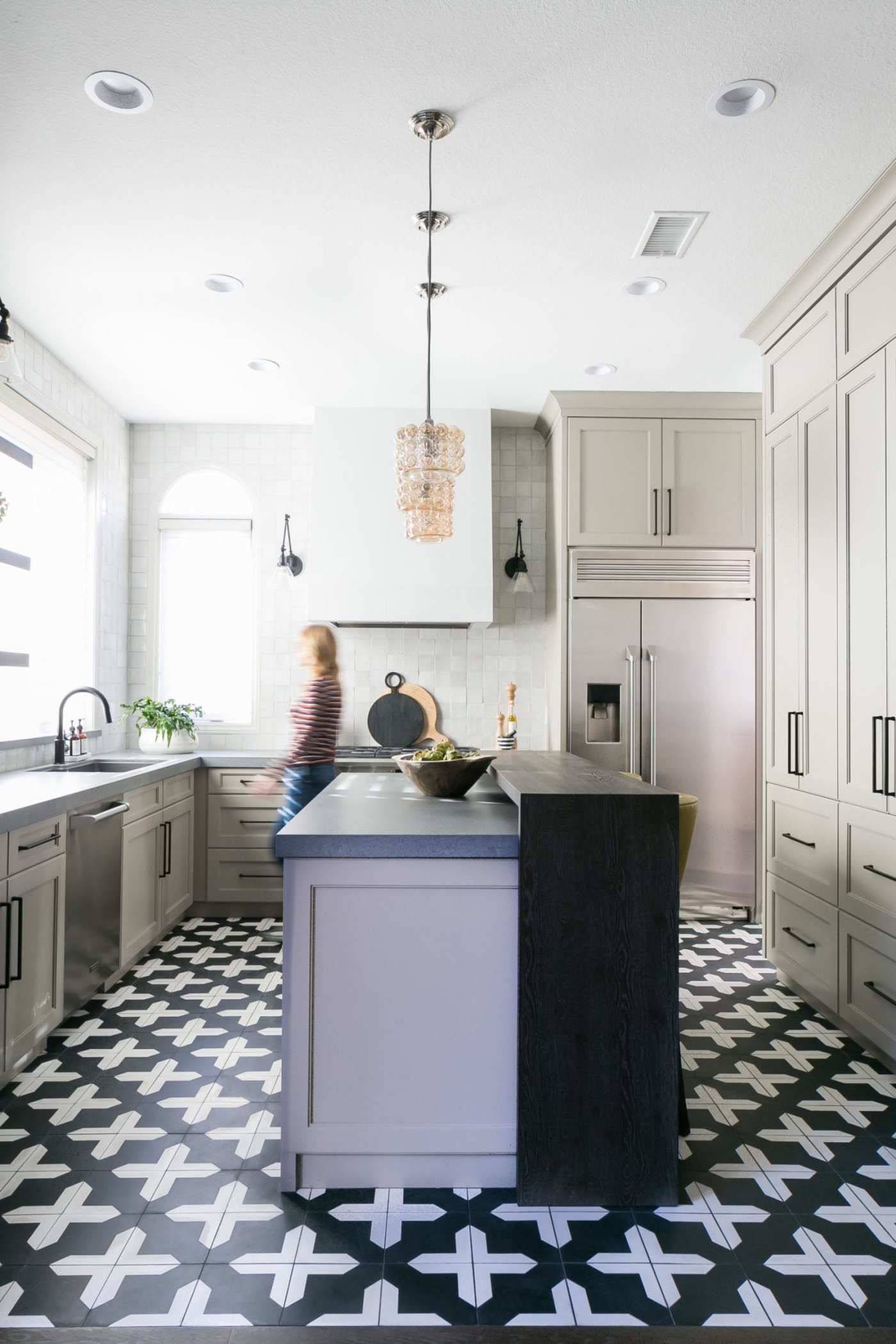 a kitchen with a black and white checkered floor.