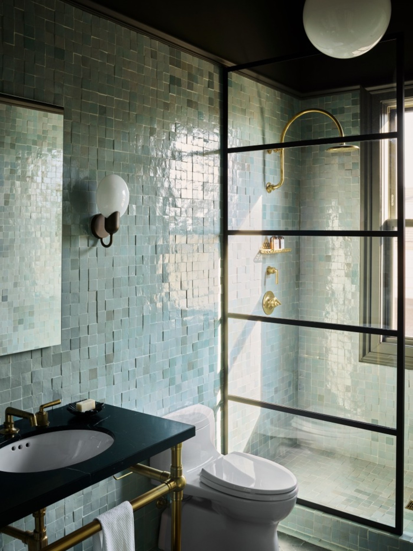 a bathroom with blue tile walls.