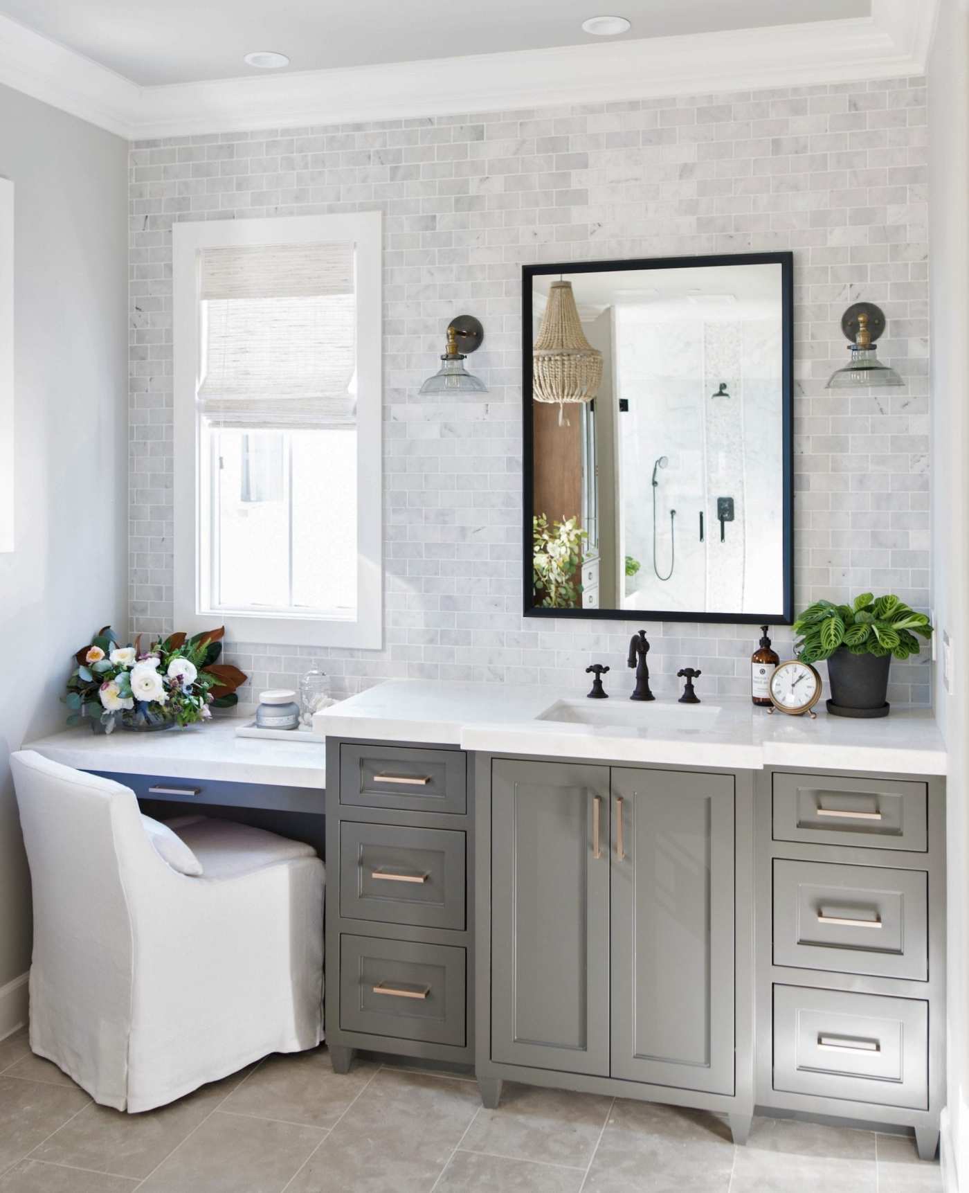 a bathroom with a gray vanity and white sink.