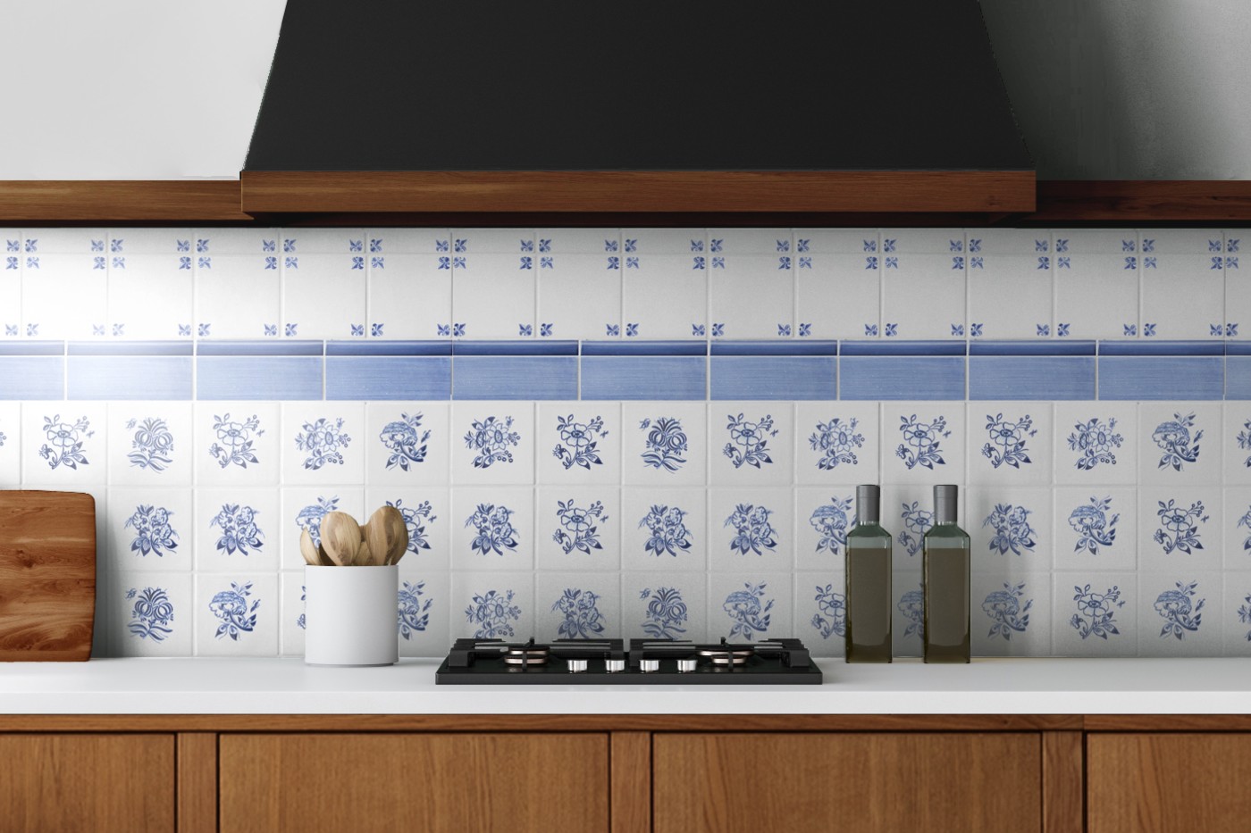 a blue and white tiled stove backsplash in a kitchen with wooden cabinets.