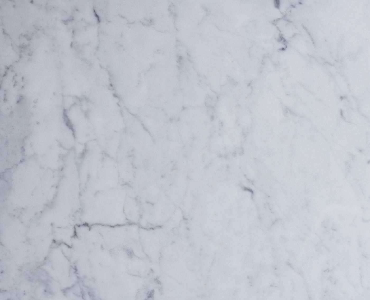 a close up of a white marble surface.