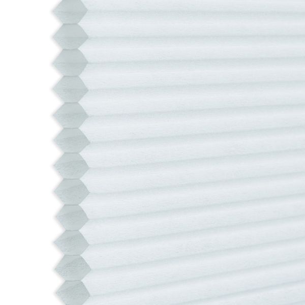 White honeycomb (cellular) blind, hexagonal pleats visible along the left edge; closed and diffusing light; photographed close-up against a neutral background, showing even soft daylight and subtle texture.