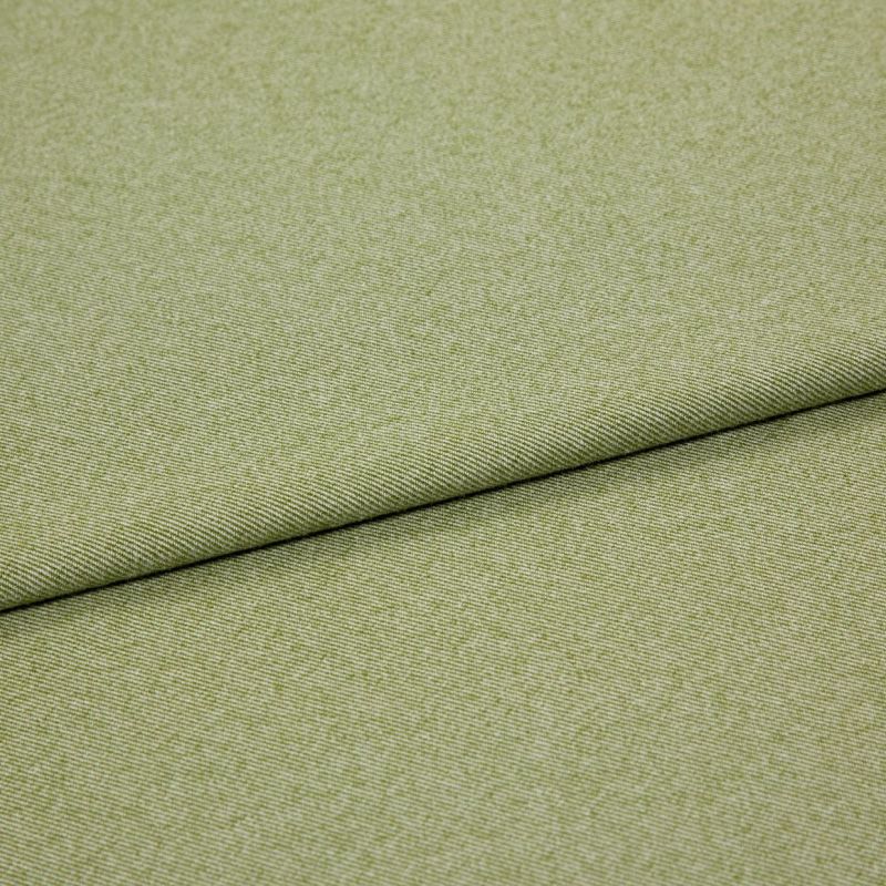 Green woven fabric (upholstery-like) folded diagonally, showing fine twill texture; layered fold creates a shadowed seam across the frame against a neutral, evenly lit background.
