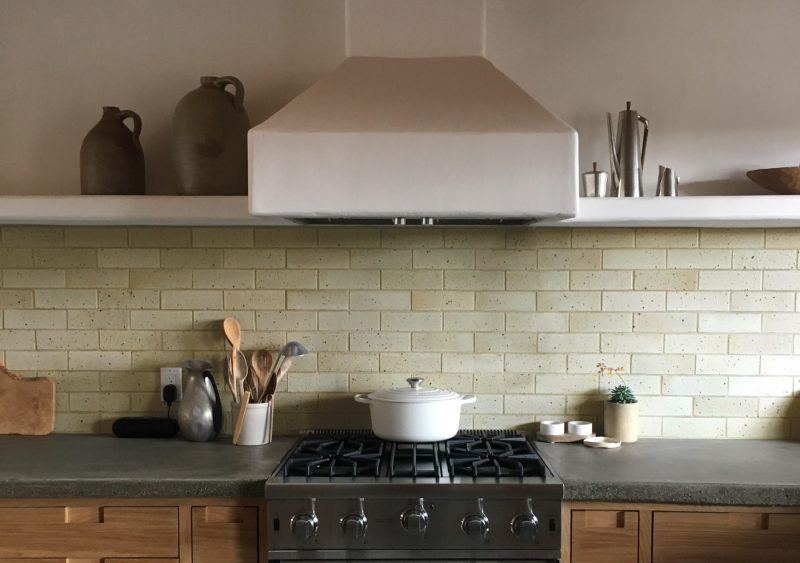 a kitchen with a stove, oven, and pots and pans.