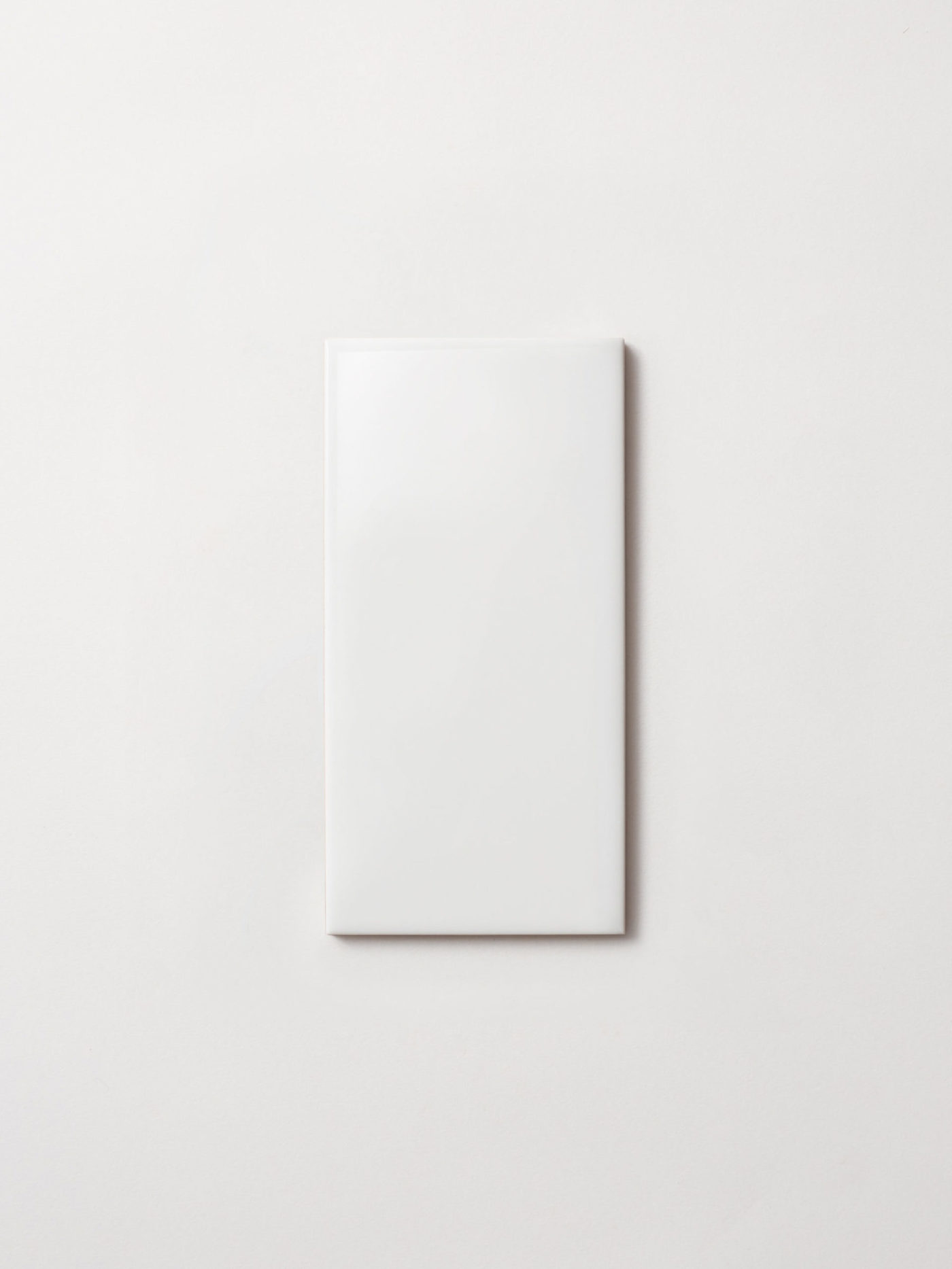 a white rectangle tile on a white surface.