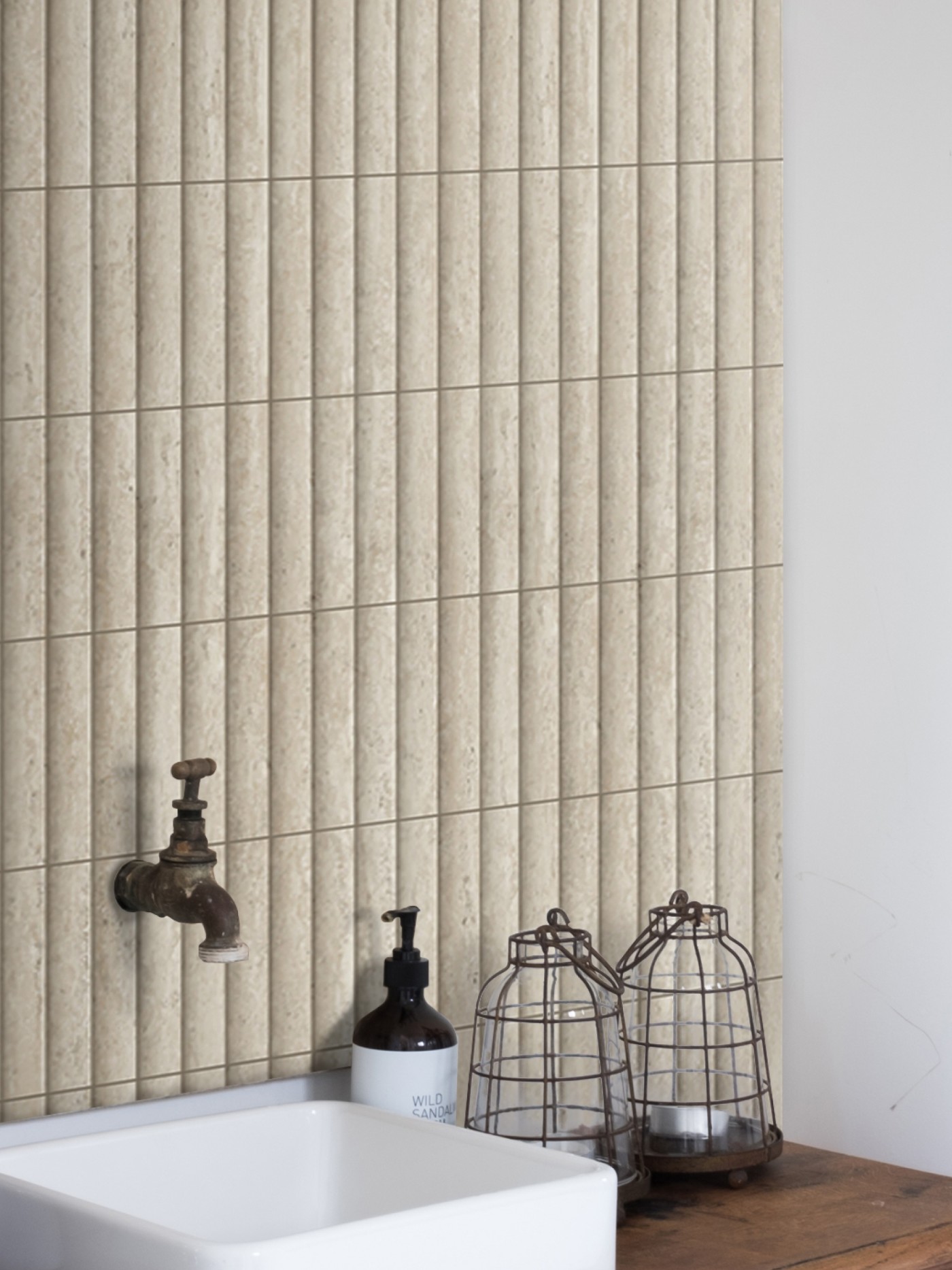 a bathroom with a wooden sink and tiled walls.