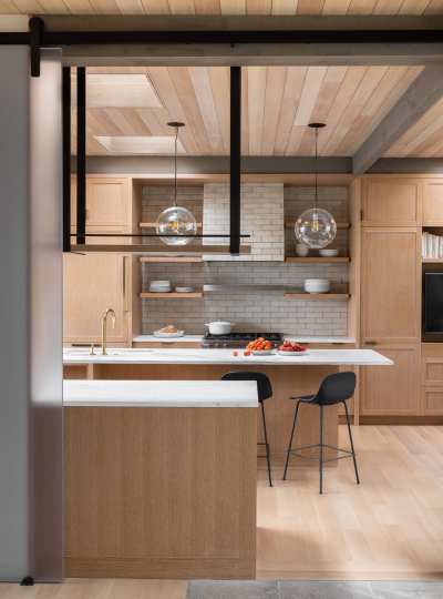 a modern kitchen with wooden cabinets and a large island.