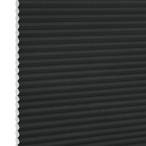 Black honeycomb (cellular) blind, fully lowered and closed with visible white hexagonal cell ends at left, blocking light; close-up interior view with neutral lighting.