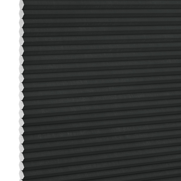 Black honeycomb (cellular) blind, fully lowered and closed with visible white hexagonal cell ends at left, blocking light; close-up interior view with neutral lighting.