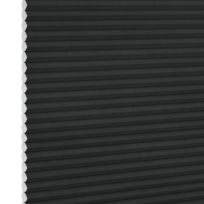 Black honeycomb (cellular) blind, fully lowered and closed with visible white hexagonal cell ends at left, blocking light; close-up interior view with neutral lighting.