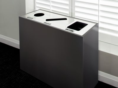 triple waste and recycling container with stainless steel lid and melamine body in a modern corporate office