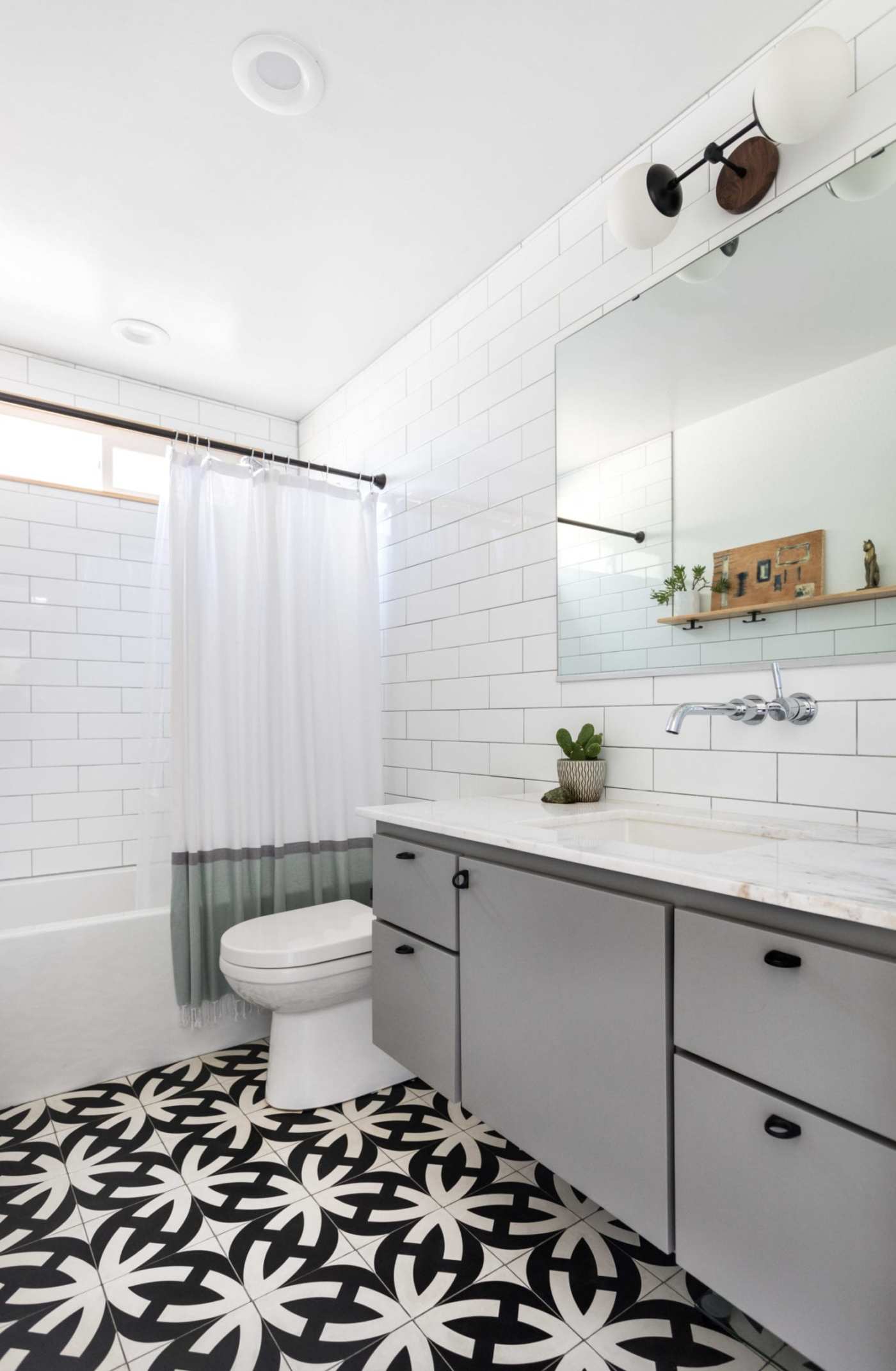 a bathroom with a black and white tile floor.