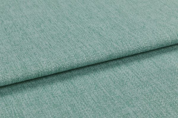 A folded teal-green textured upholstery fabric, layered with a visible fold across the frame; close-up view showing woven pile under soft, even studio lighting.