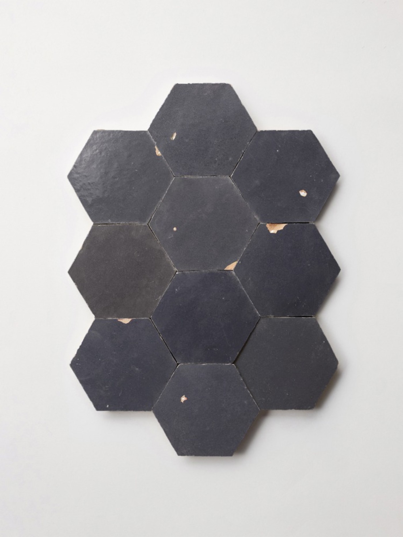 black hexagon tiles on a white surface.