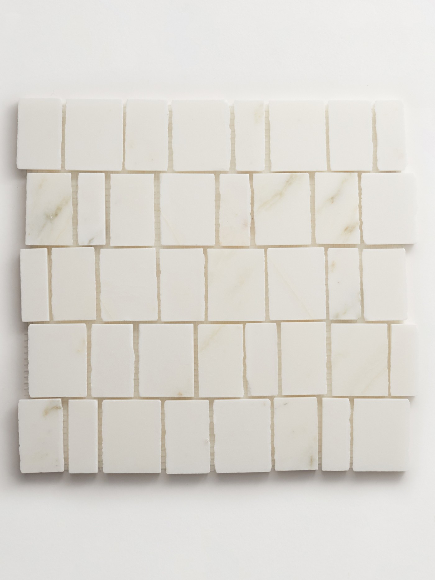 a white marble mosaic tile on a white surface.