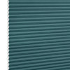 Teal honeycomb (cellular) blind, fully lowered with visible white hexagonal cell edges, closed over a window; minimalist product-style setting with even, neutral lighting.
