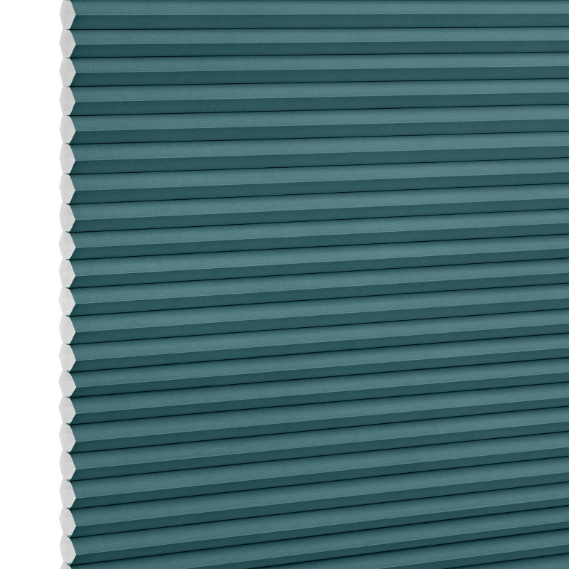 Teal honeycomb (cellular) blind, fully lowered with visible white hexagonal cell edges, closed over a window; minimalist product-style setting with even, neutral lighting.