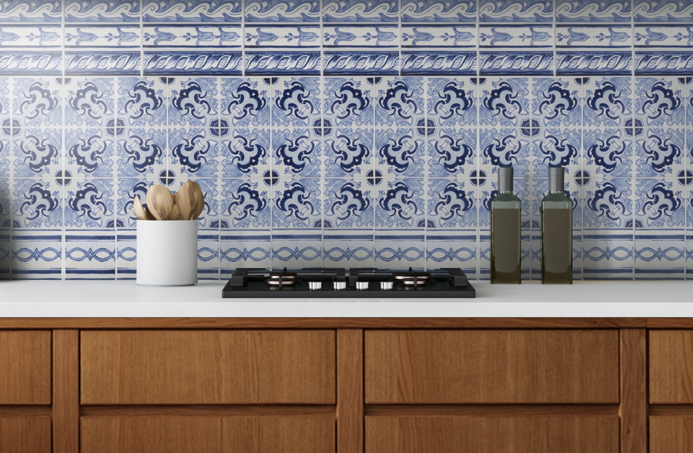 a blue and white tiled stove backsplash in a kitchen with wooden cabinets.