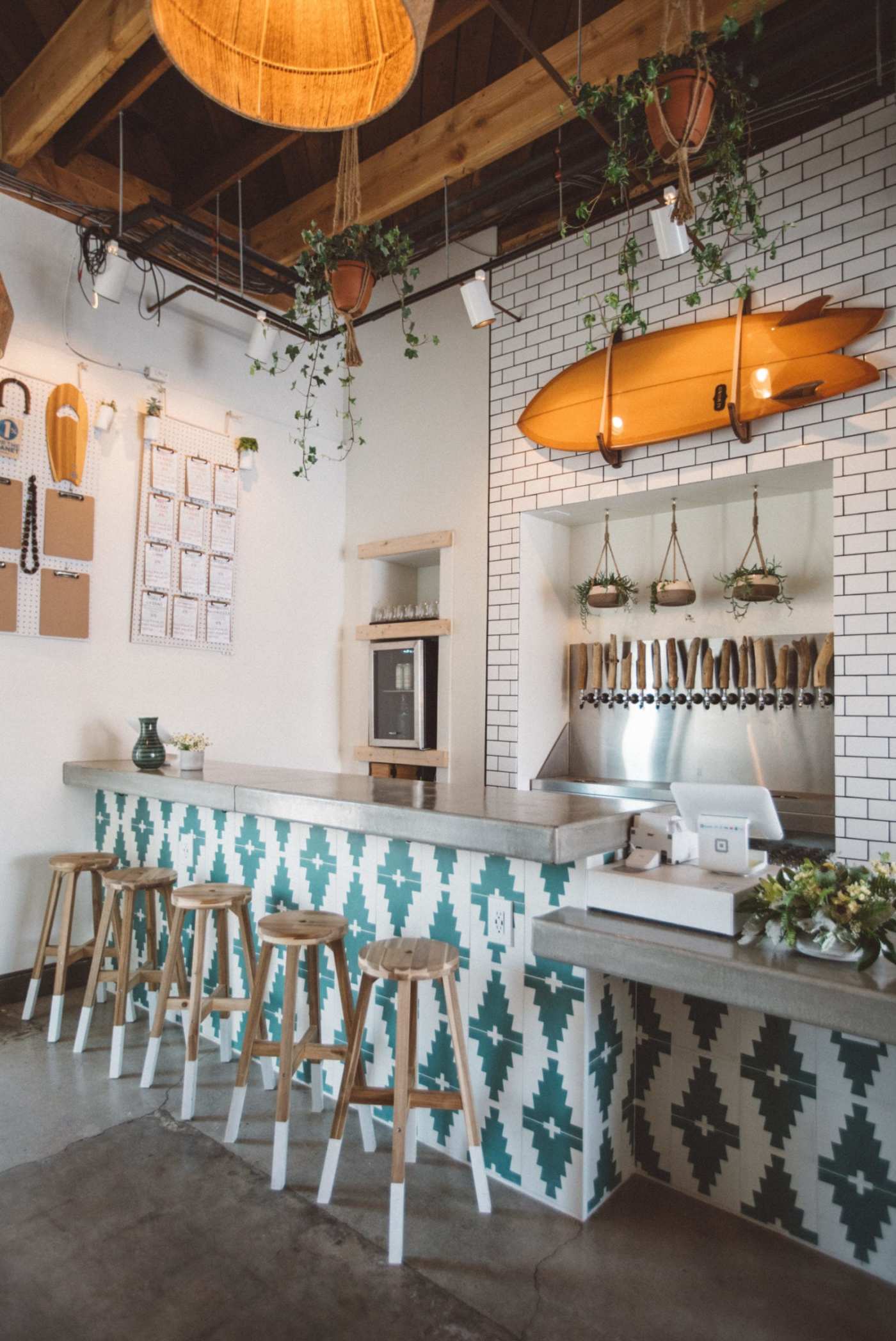 a restaurant with stools and a blue and white tiled counter.