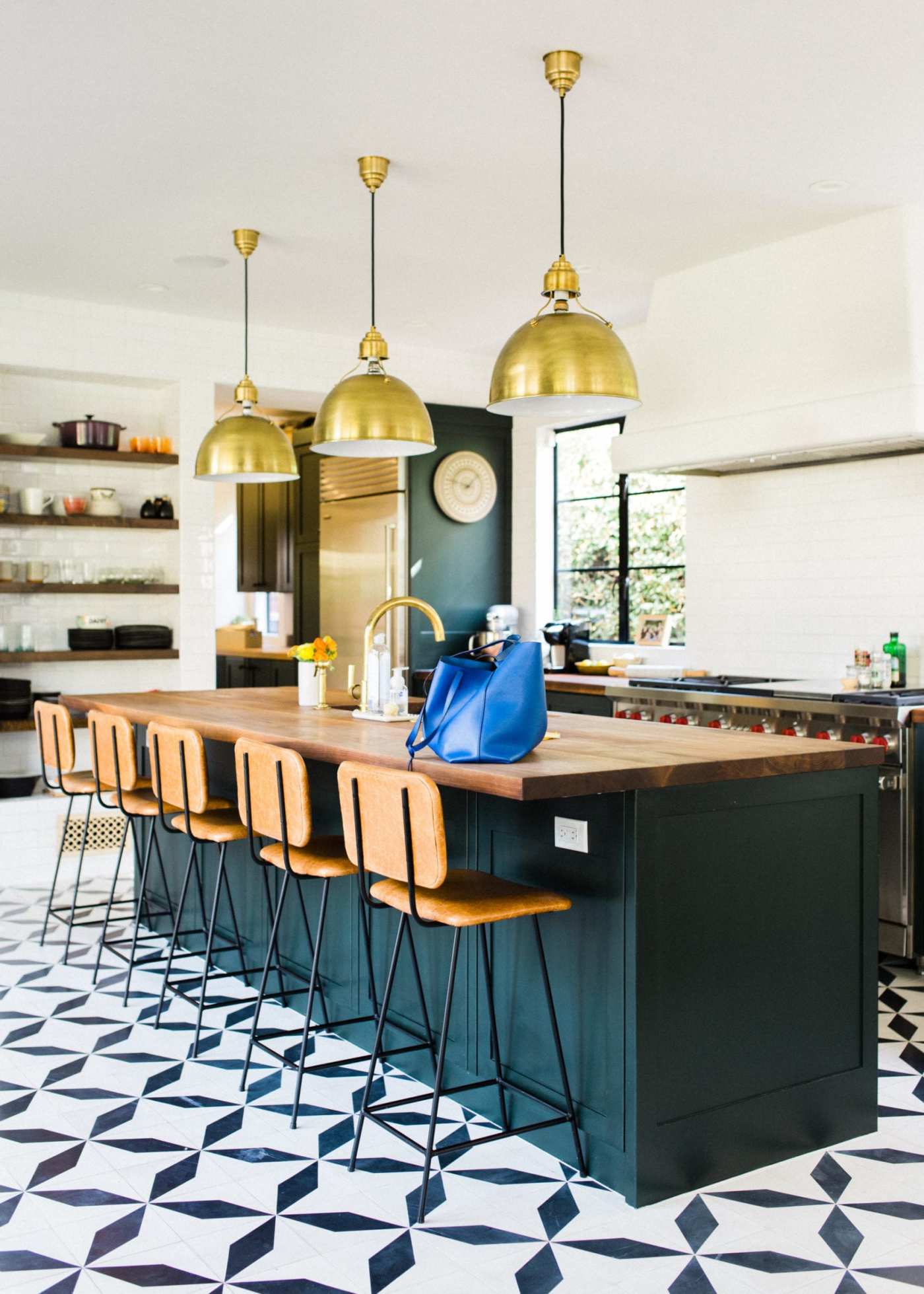 a kitchen with a black and white tiled floor.