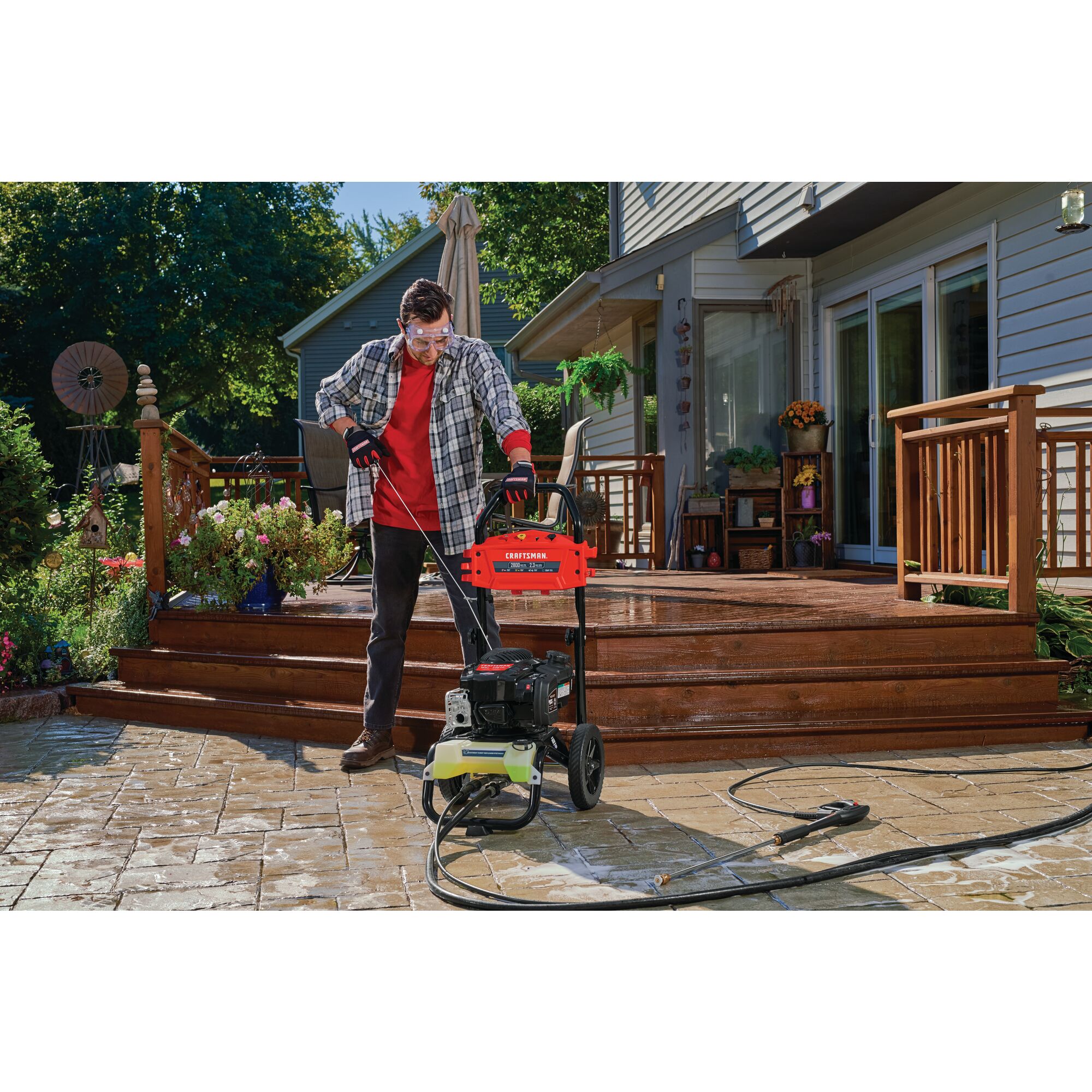 2800 Max P S I / 2.3 max G P M Pressure washer being used by a person to start washer.