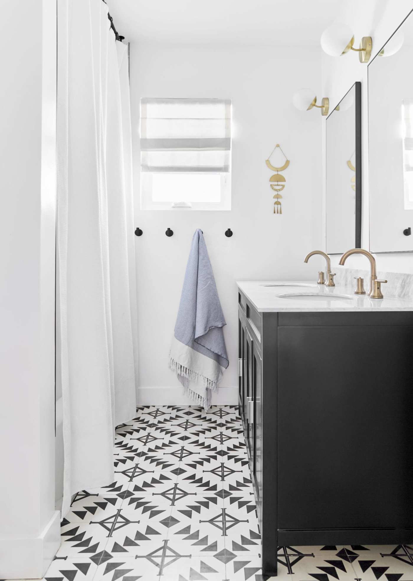 a bathroom with a black and white tiled floor.