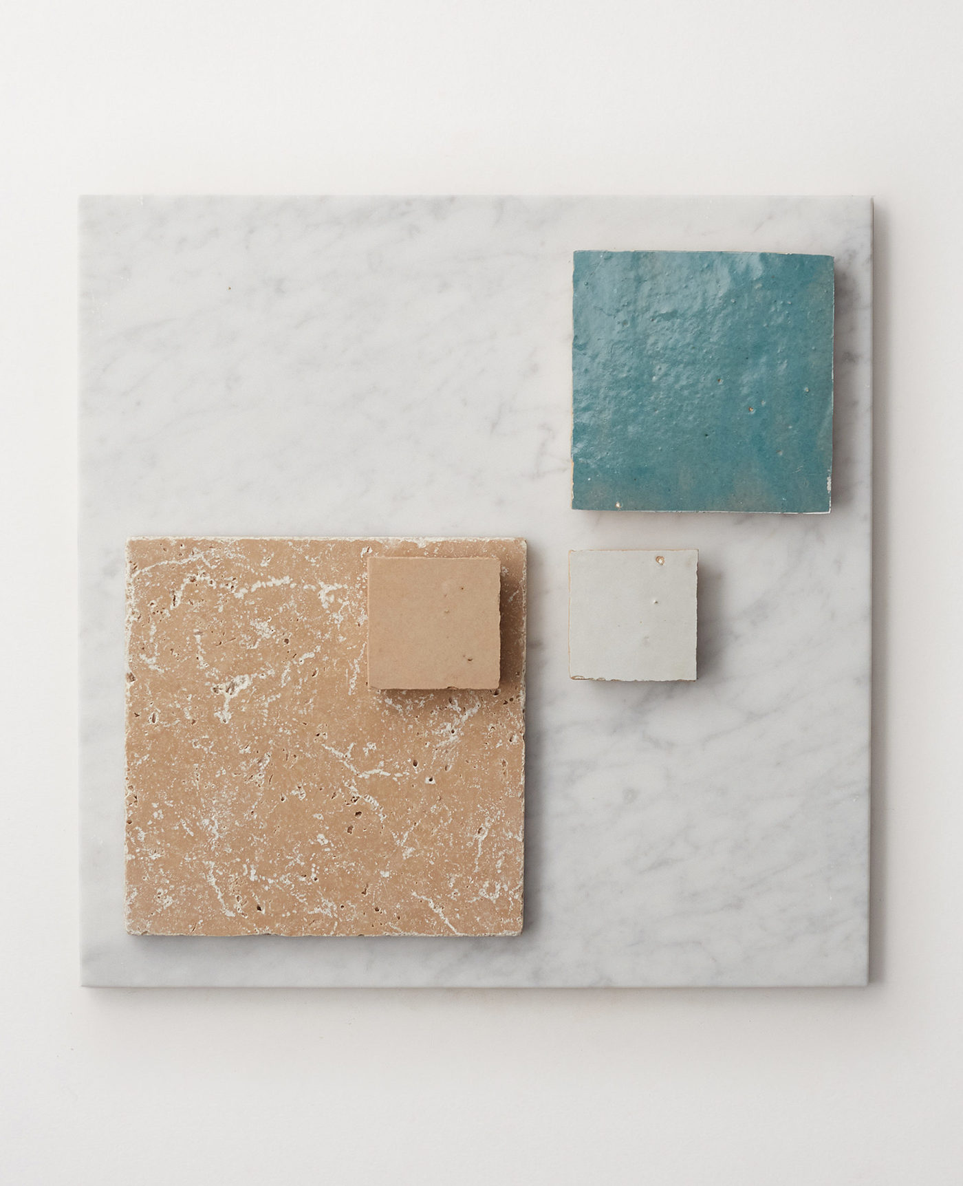 an arrangement of various assorted tile on a white surface.