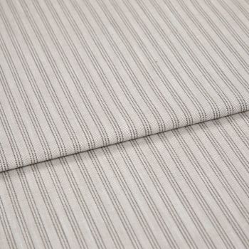 Beige woven fabric with thin vertical gray pinstripes, folded once and overlapping, lying flat as a sample in soft, diffuse lighting—close-up view emphasizing texture and pattern.