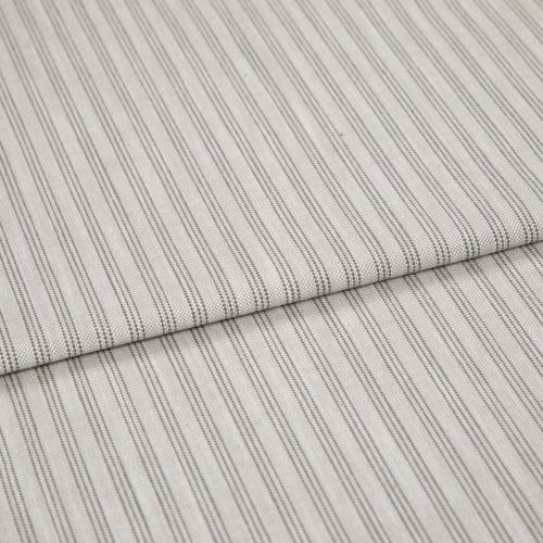 Beige woven fabric with thin vertical gray pinstripes, folded once and overlapping, lying flat as a sample in soft, diffuse lightingâ€”close-up view emphasizing texture and pattern.