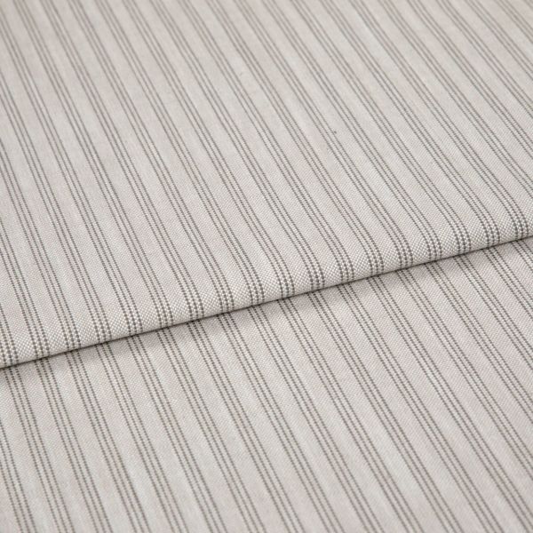 Beige woven fabric with thin vertical gray pinstripes, folded once and overlapping, lying flat as a sample in soft, diffuse lighting—close-up view emphasizing texture and pattern.