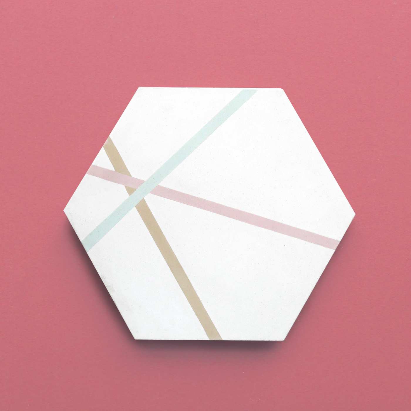 a white hexagonal tile on a pink background.